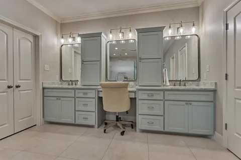 a bathroom with a sink vanity and mirror