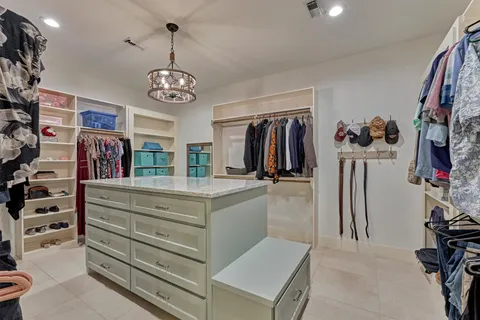 a view of walk in closet with clothes