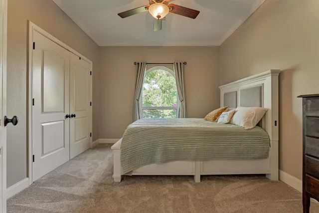 a bedroom with a bed and a chandelier