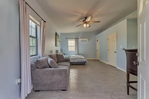 a living room with furniture and a chandelier