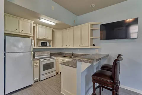 a kitchen with a stove a sink and a microwave