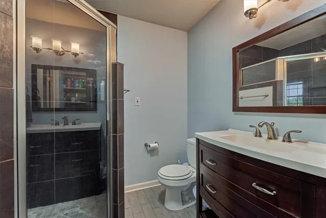 a bathroom with a toilet sink and mirror