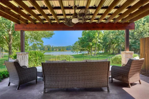 a view of a patio with a table chairs and a yard