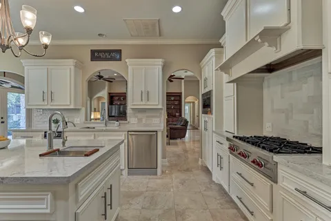 a kitchen with sink cabinets and stove