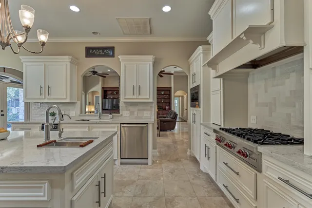 a kitchen with sink cabinets and stove