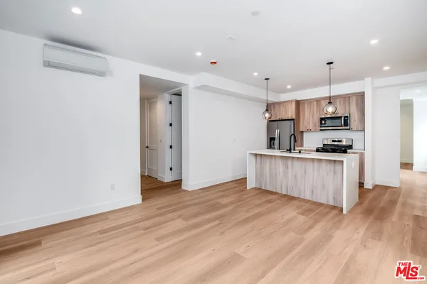 a kitchen with a refrigerator and a stove top oven