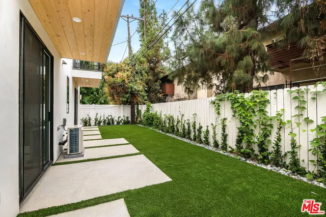 a view of house with backyard