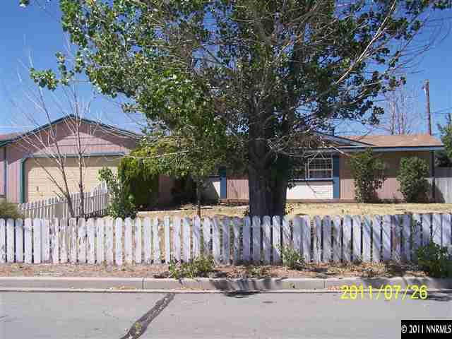 17255 Waxwing Street Reno, NV 89508 - Photo 13 of 13 a view of a house with a small yard and a large tree