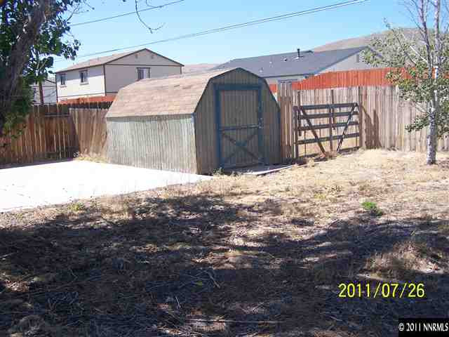 17255 Waxwing Street Reno, NV 89508 - Photo 9 of 13 a view of a house with a yard covered in snow
