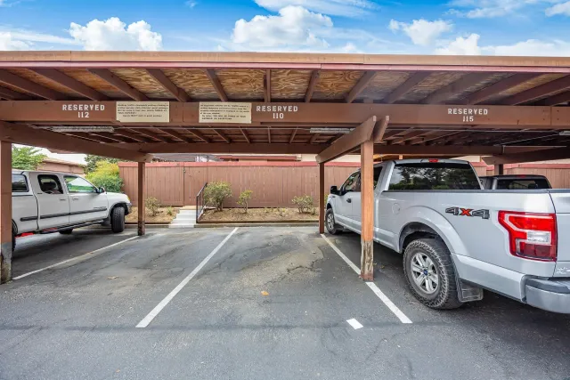a view of parking garage with cars parked