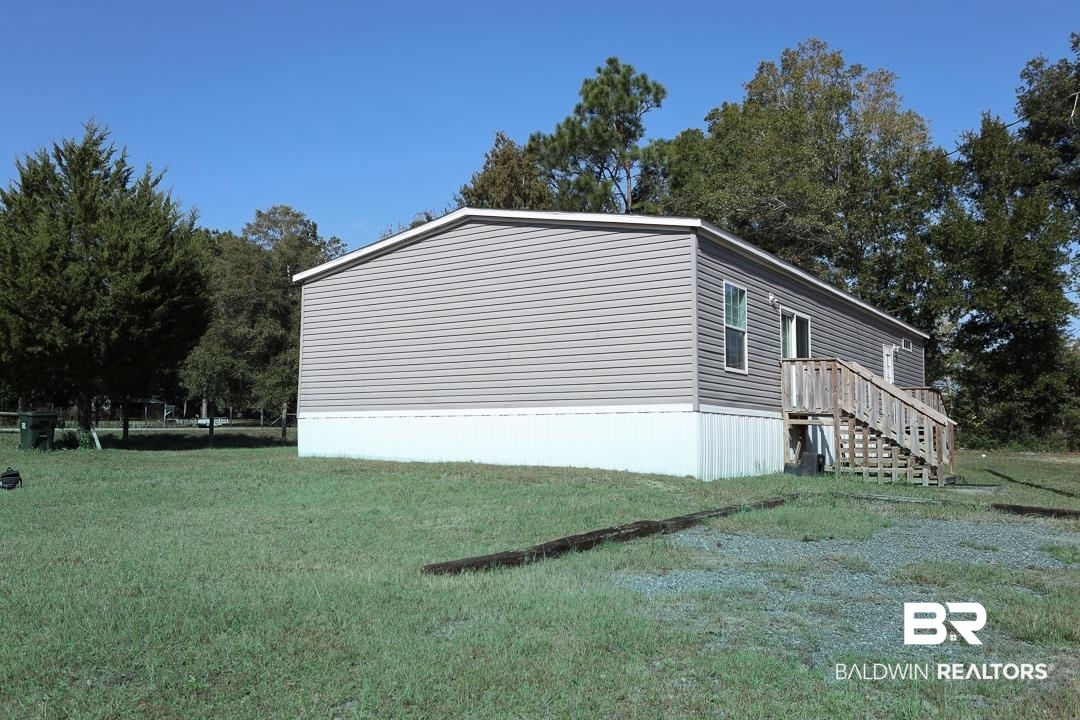 19180 Horseshoe Circle Seminole, AL 36574 - Photo 36 of 38 View of side of property featuring a lawn