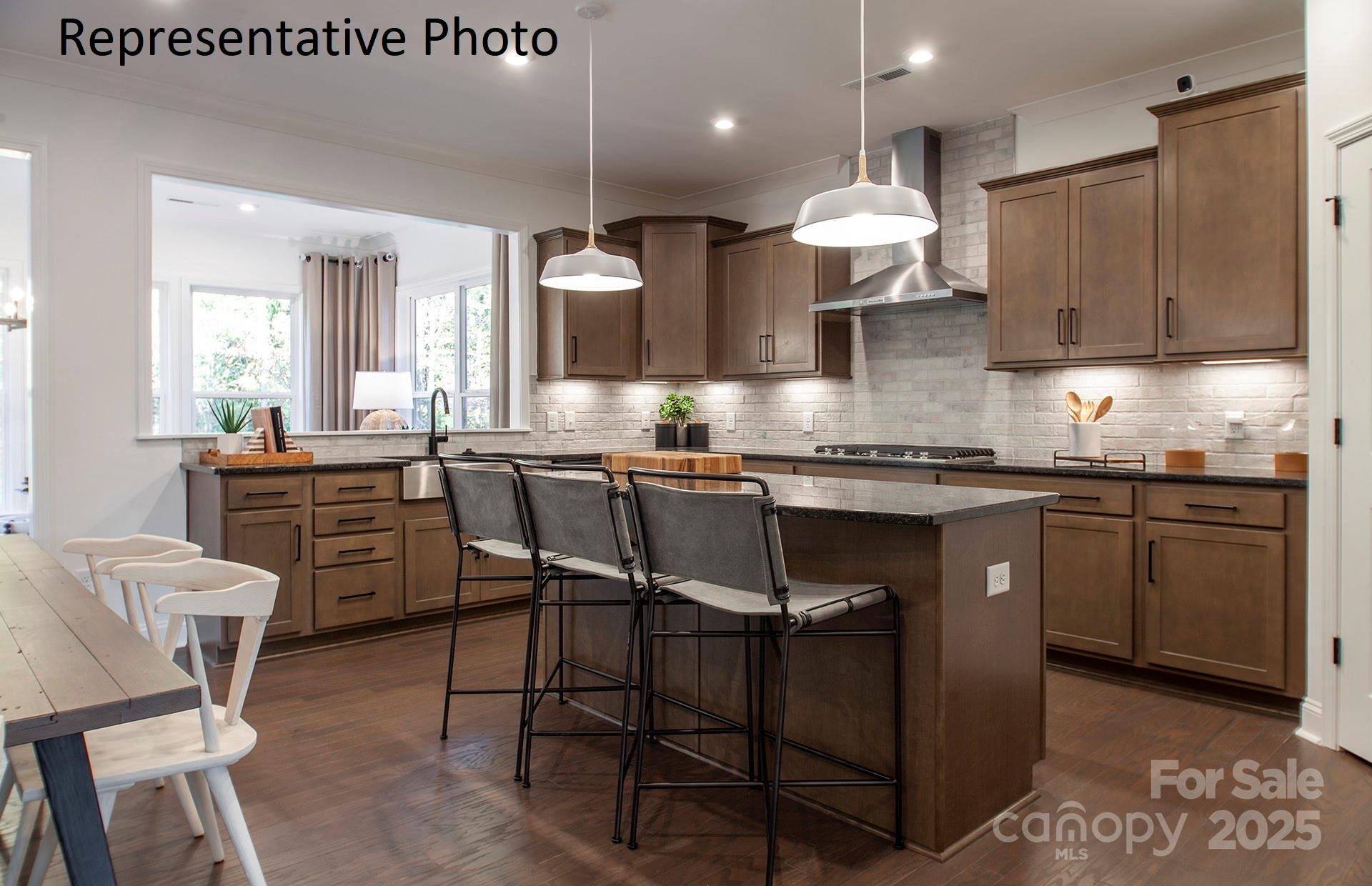 4707 Formation Court, Unit 49 Lancaster, SC 29720 - Photo 9 of 21 a kitchen with stainless steel appliances granite countertop a table chairs sink and stove top oven
