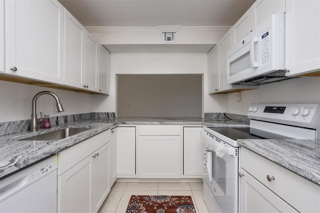 9410 Live Oak Place, Unit 203 Davie, FL 33324 - Photo 12 of 40 a kitchen with granite countertop a sink stainless steel appliances and cabinets