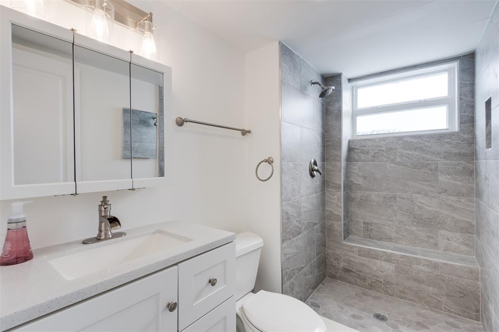 9410 Live Oak Place, Unit 203 Davie, FL 33324 - Photo 16 of 40 a bathroom with a sink a toilet and shower