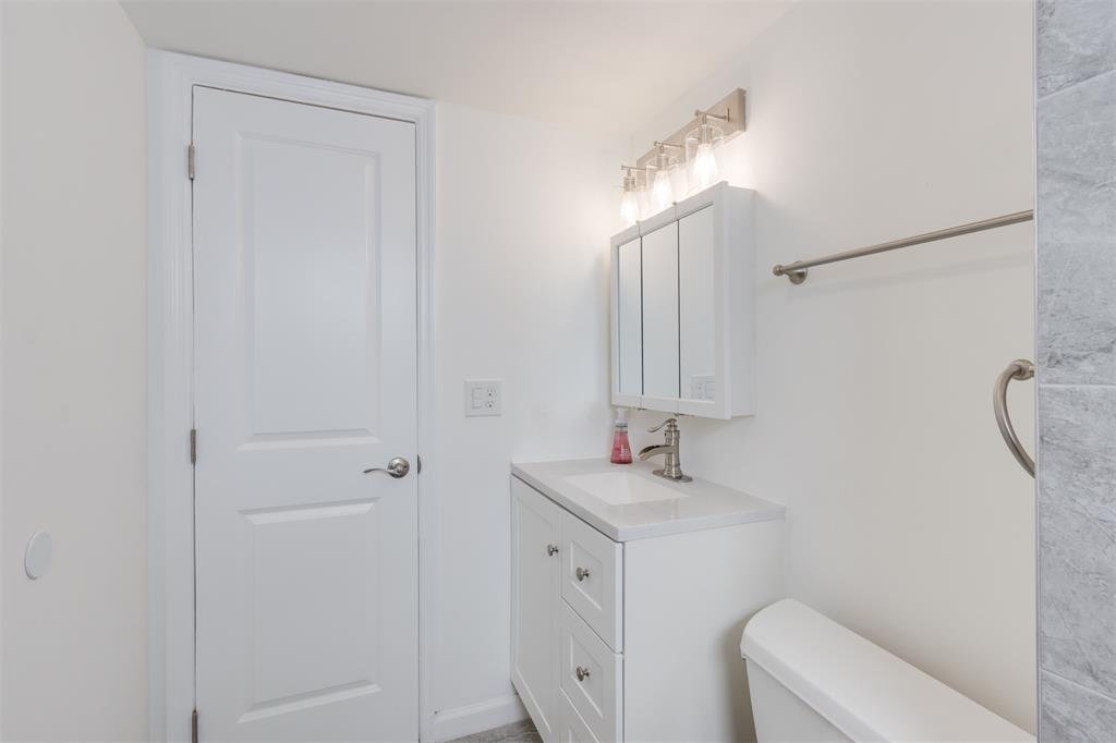 9410 Live Oak Place, Unit 203 Davie, FL 33324 - Photo 17 of 40 a bathroom with a sink a toilet and a mirror