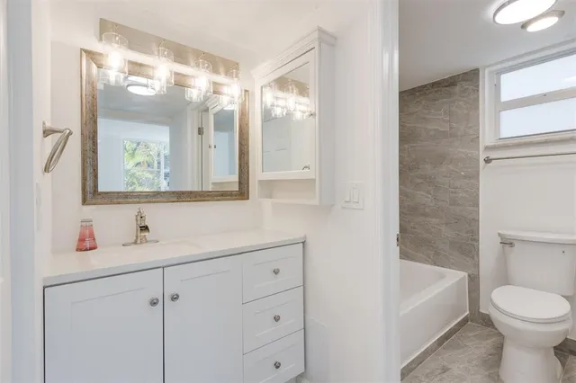 a bathroom with a white bath tub and a shower