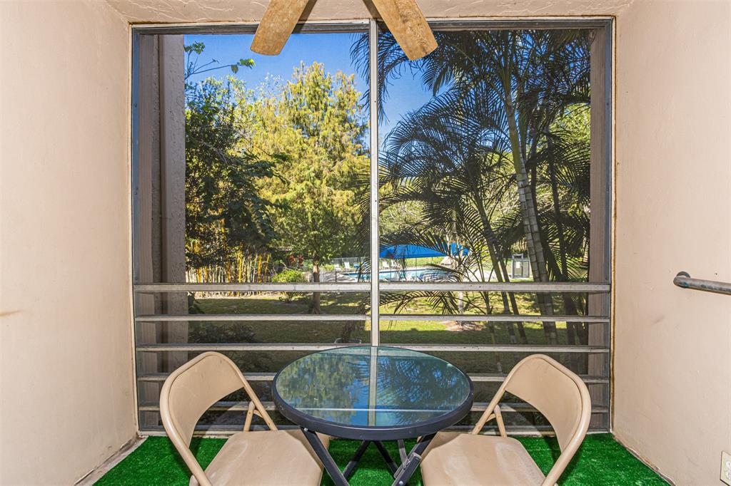 9410 Live Oak Place, Unit 203 Davie, FL 33324 - Photo 29 of 40 a picture of a table and chair in a patio