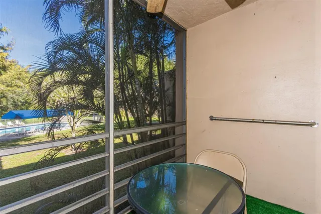 a backyard of a house with plants and outdoor seating