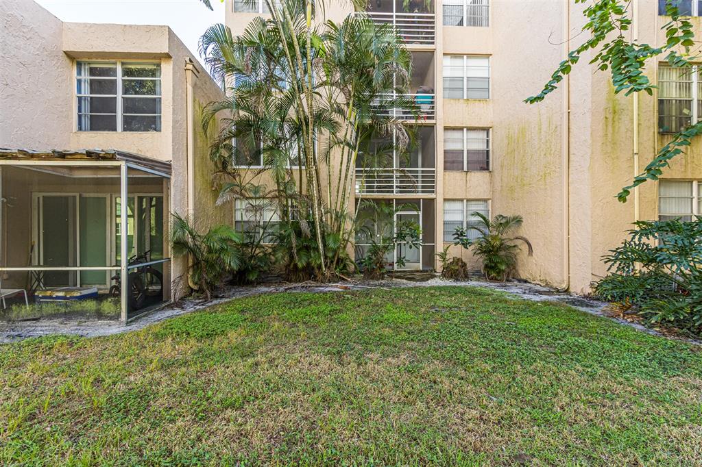 9410 Live Oak Place, Unit 203 Davie, FL 33324 - Photo 31 of 40 a backyard of a house with plants and outdoor seating
