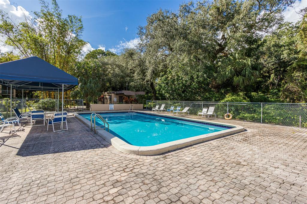 9410 Live Oak Place, Unit 203 Davie, FL 33324 - Photo 33 of 40 a view of a swimming pool and lounge chairs
