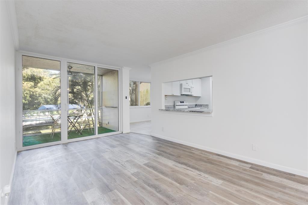 9410 Live Oak Place, Unit 203 Davie, FL 33324 - Photo 4 of 40 a view of kitchen and wooden floor