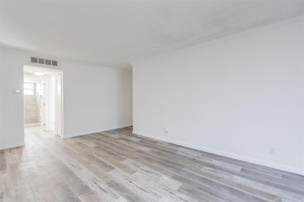 9410 Live Oak Place, Unit 203 Davie, FL 33324 - Photo 6 of 40 a view of an empty room with wooden floor and a window