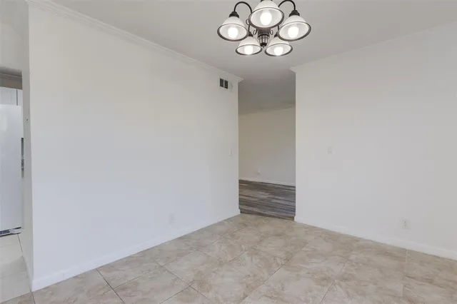 a view of a chandelier fan and kitchen view