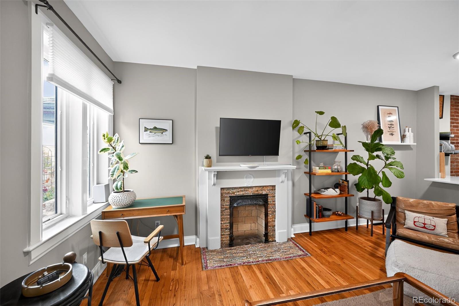 726 Fox Street Denver, CO 80204 - Photo 4 of 33 a living room with furniture a fireplace and a flat screen tv