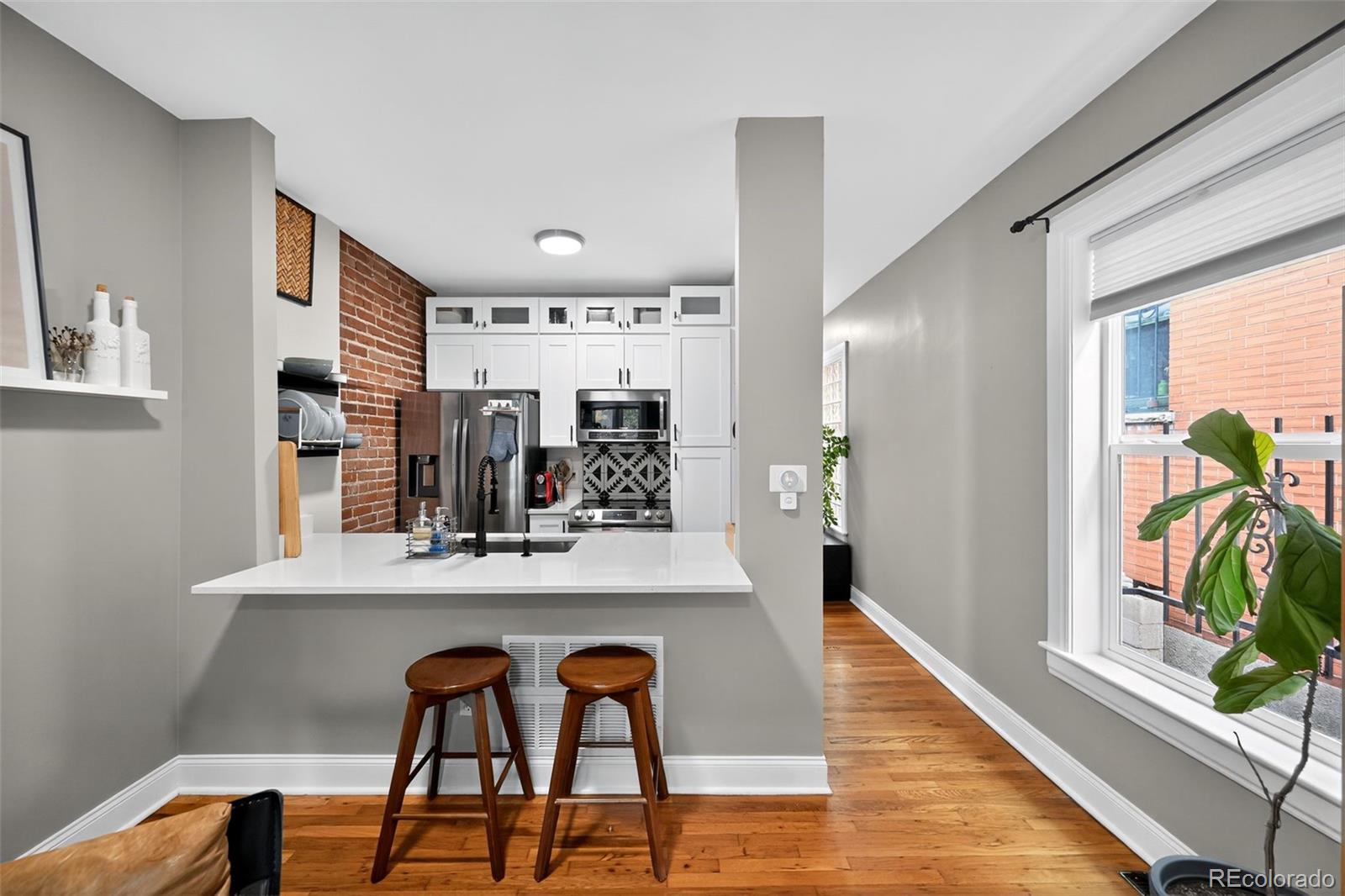 726 Fox Street Denver, CO 80204 - Photo 9 of 33 a view of a dining room with furniture and a potted plant