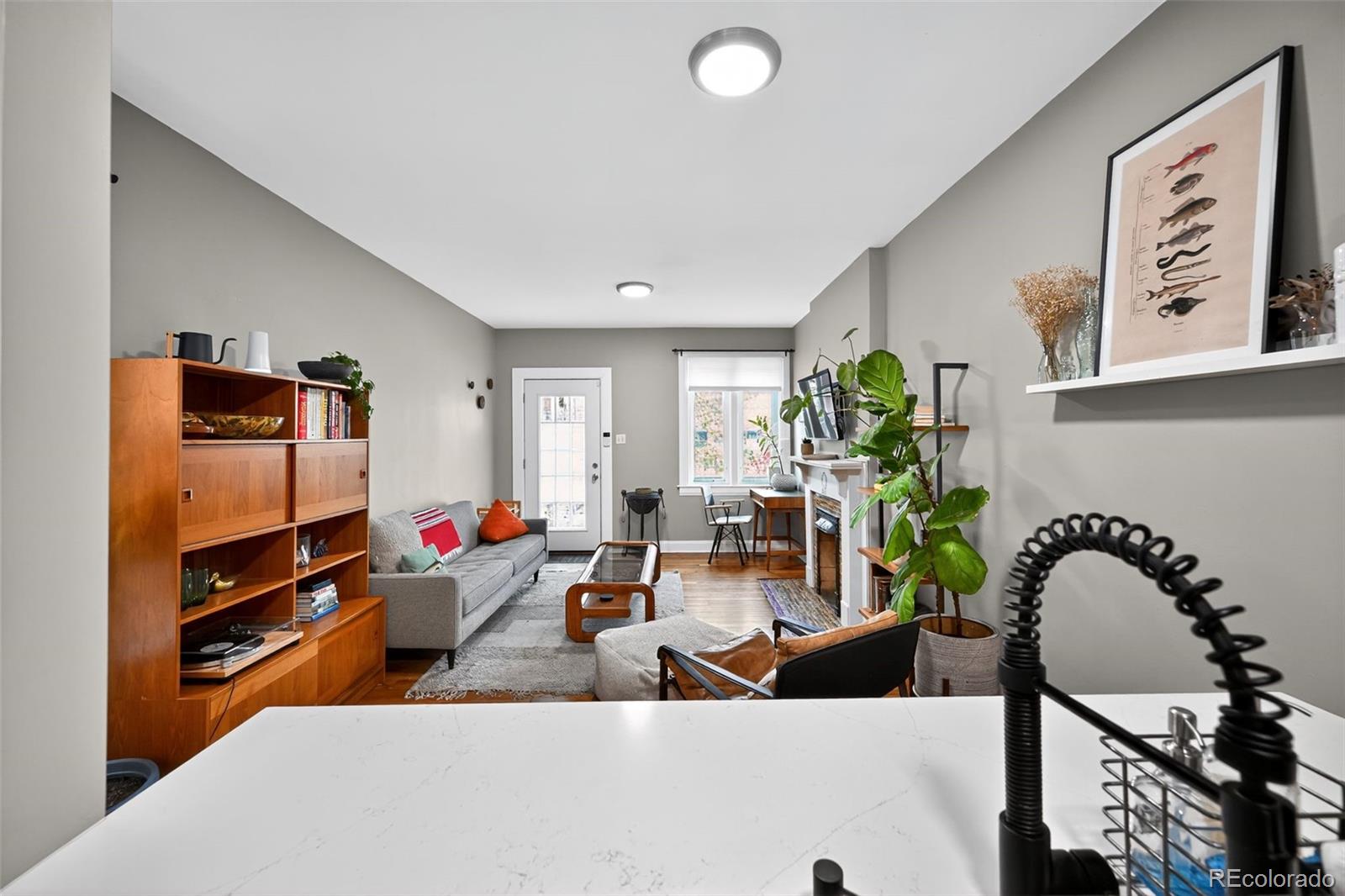 726 Fox Street Denver, CO 80204 - Photo 10 of 33 a living room with furniture and a flat screen tv