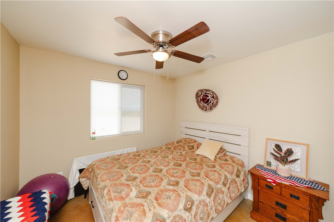 2948 Pinal Road Golden Valley, AZ 86413 - Photo 21 of 59 Bedroom featuring a ceiling fan with integrated lighting, a window with horizontal blinds, and neutral-toned walls