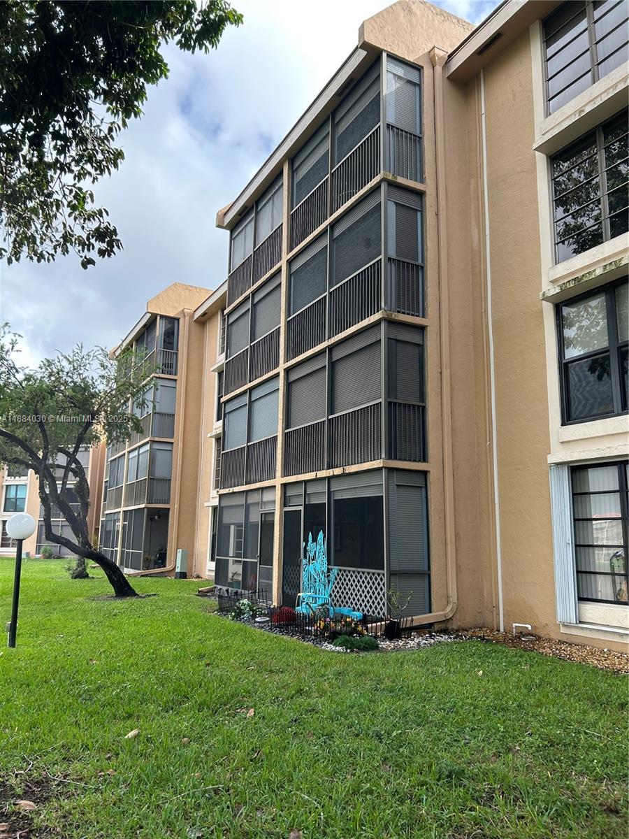 6011 Coral Lake Drive, Unit 111 Margate, FL 33063 - Photo 2 of 5 a front view of a house with a yard