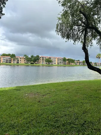 a view of a lake with houses in the back