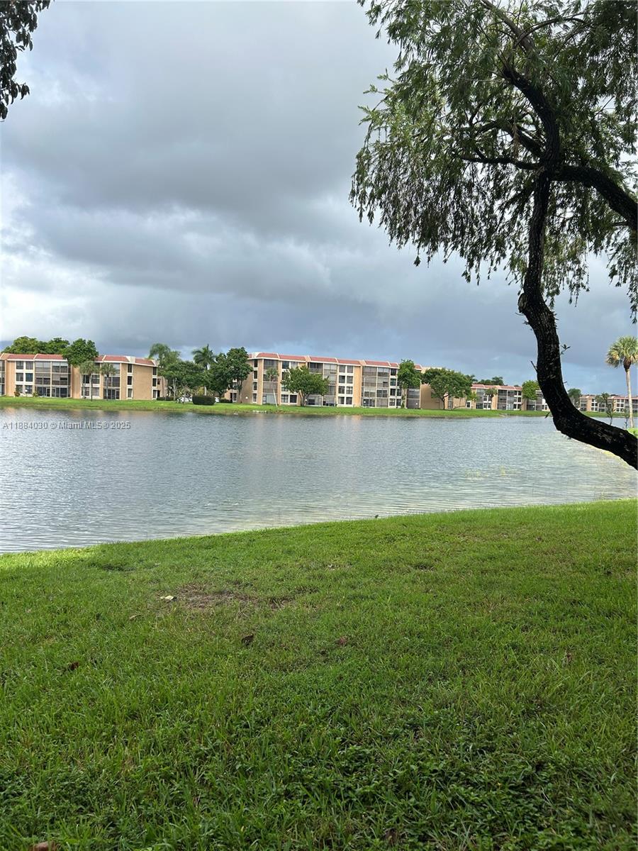 6011 Coral Lake Drive, Unit 111 Margate, FL 33063 - Photo 4 of 5 a view of a lake with houses in the back