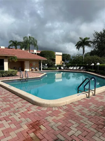 a view of a swimming pool with a patio