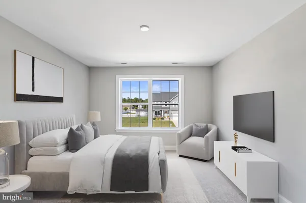 a bedroom with bed and a flat screen tv