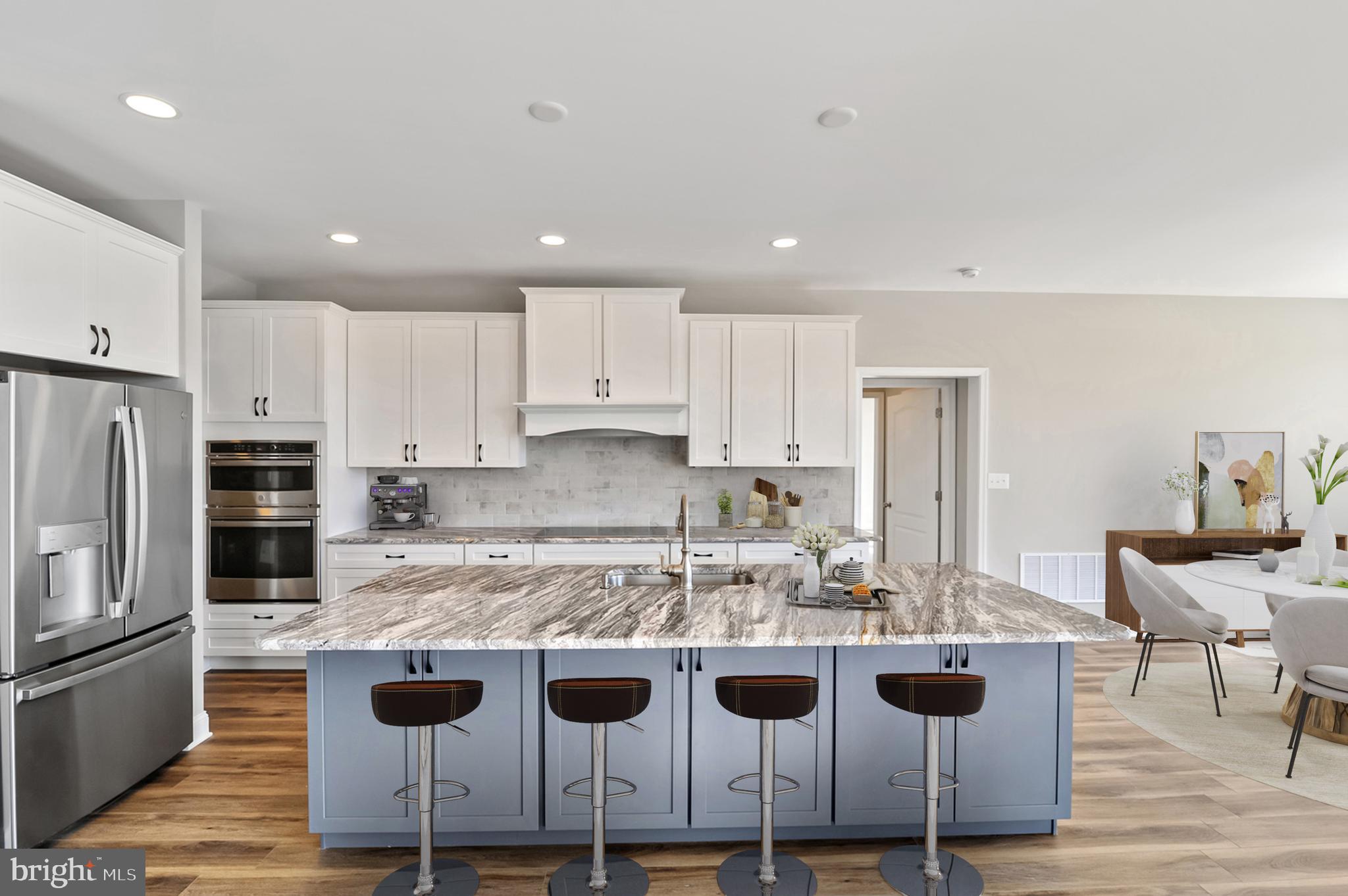 296 Robbins Road, Unit GEO Frederica, DE 19946 - Photo 6 of 16 a kitchen with a kitchen island white cabinets and stainless steel appliances