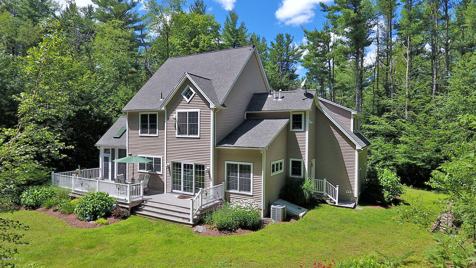 113 Pike Road Otis, MA 01253 - Photo 2 of 2 a front view of a house with a yard porch and green space