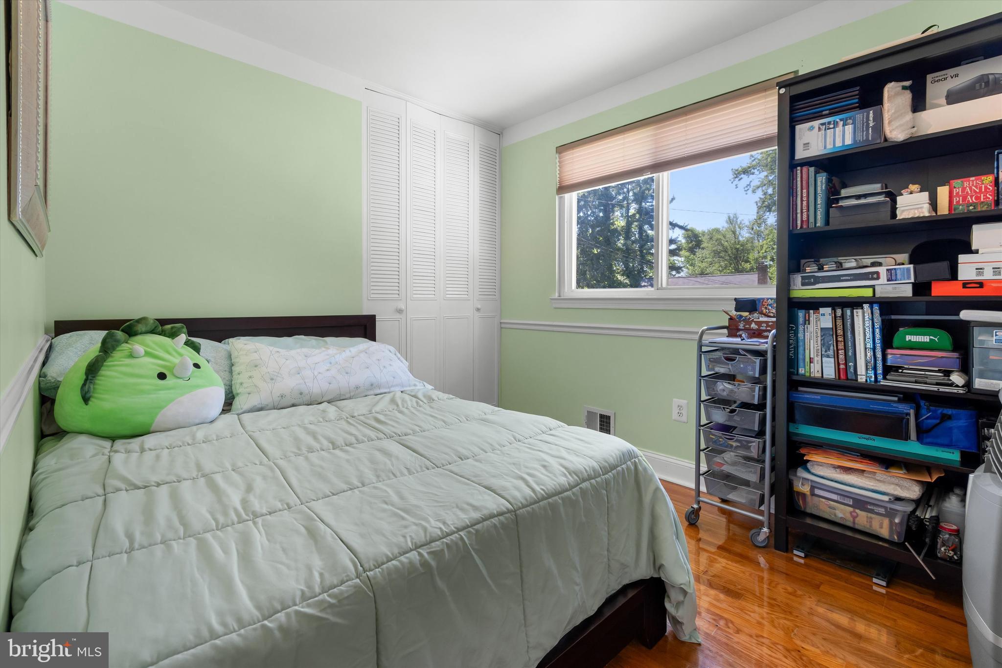 8304 Harland Drive Springfield, VA 22152 - Photo 23 of 39 a bedroom with a bed and a book shelf