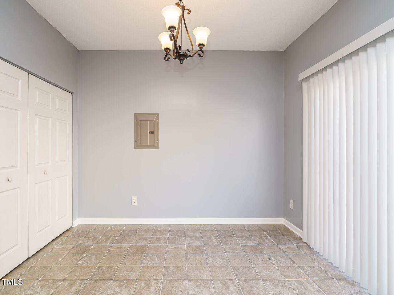 125 Watertree Lane Apex, NC 27502 - Photo 14 of 32 an empty room with a chandelier fan