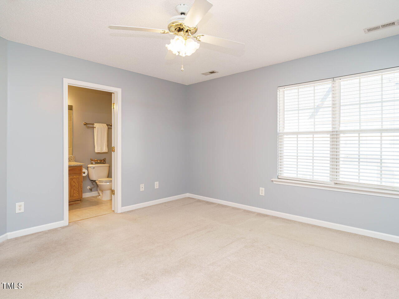 125 Watertree Lane Apex, NC 27502 - Photo 19 of 32 a view of an empty room with a window