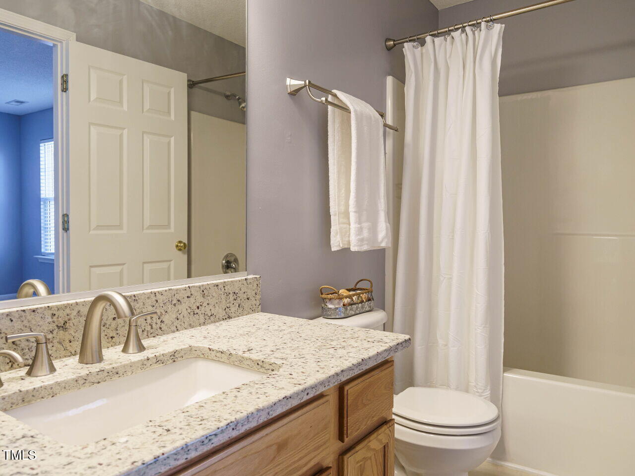 125 Watertree Lane Apex, NC 27502 - Photo 21 of 32 a bathroom with a granite countertop sink toilet and shower