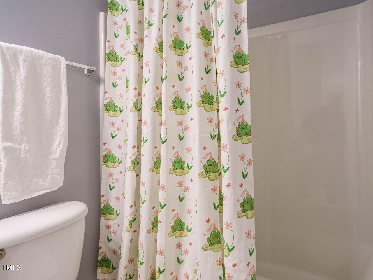 125 Watertree Lane Apex, NC 27502 - Photo 25 of 32 a white toilet sitting next to a shower curtain