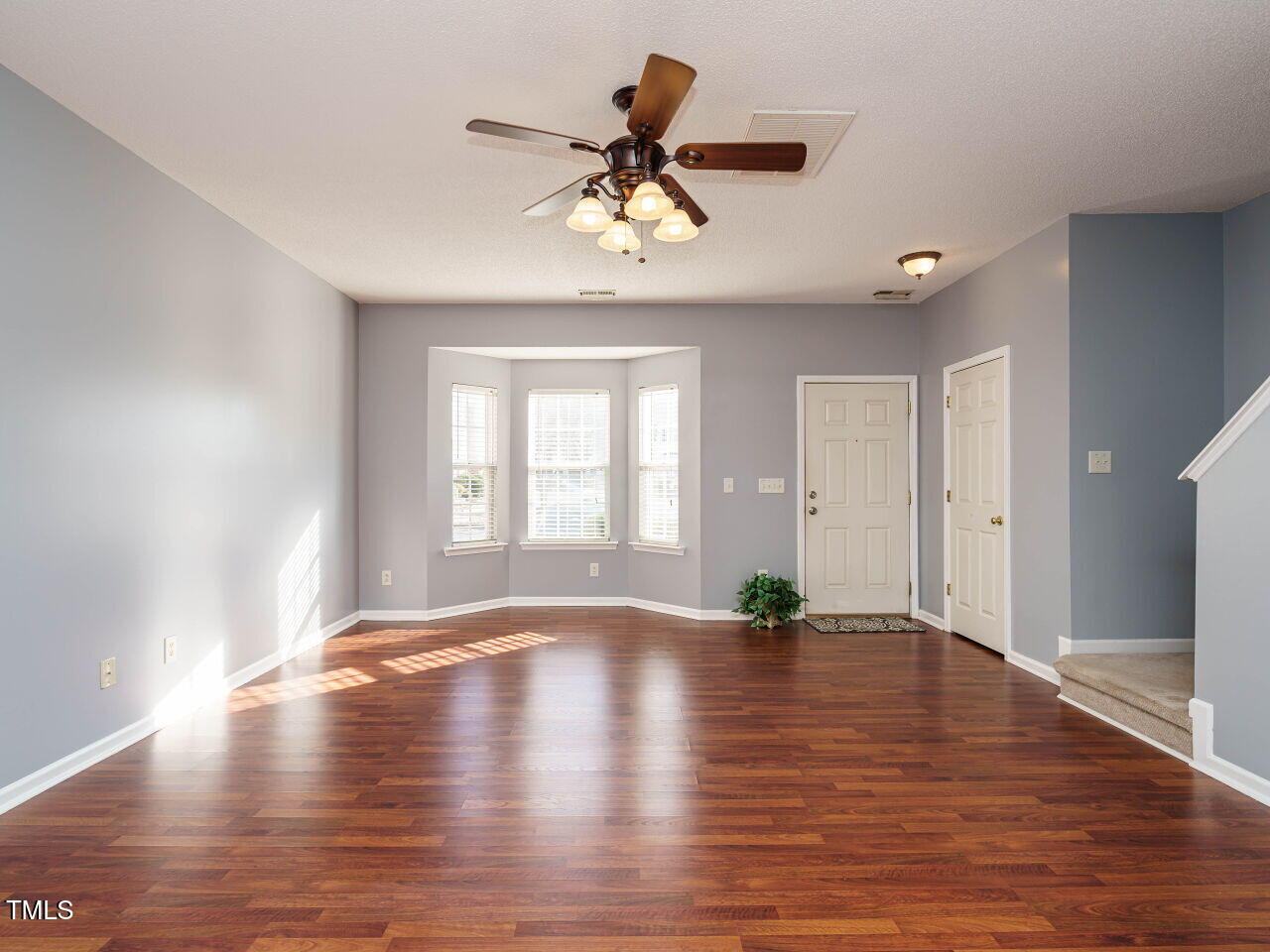 125 Watertree Lane Apex, NC 27502 - Photo 2 of 32 a view of empty room with wooden floor and fan
