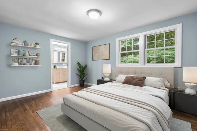 a bedroom with a large bed and a large window