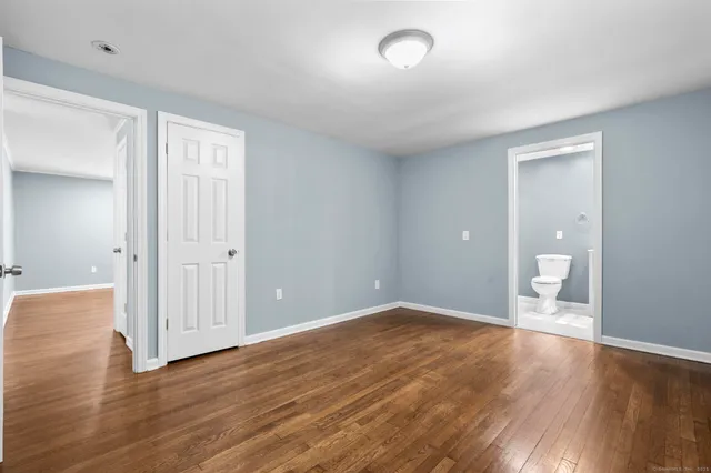 a view of a room with wooden floor and white walls