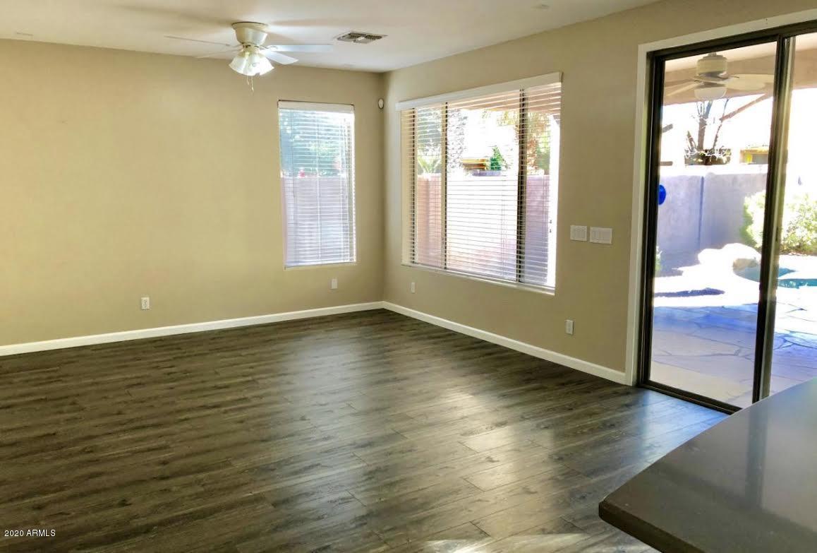 140 West Cardinal Way Chandler, AZ 85286 - Photo 11 of 44 an empty room with wooden floor and windows