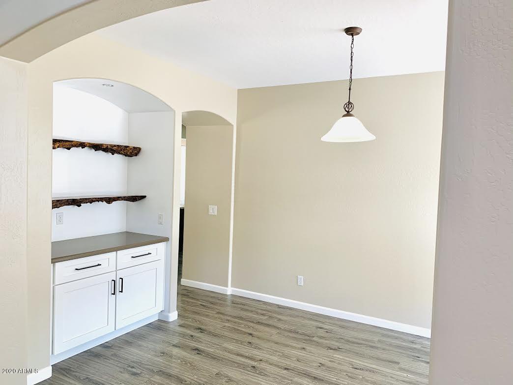 140 West Cardinal Way Chandler, AZ 85286 - Photo 14 of 44 a view of a kitchen with white cabinets and wooden floor