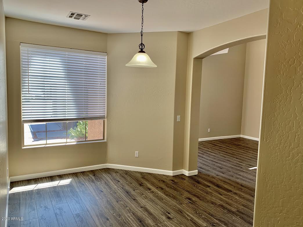 140 West Cardinal Way Chandler, AZ 85286 - Photo 15 of 44 a view of an empty room with wooden floor and a window
