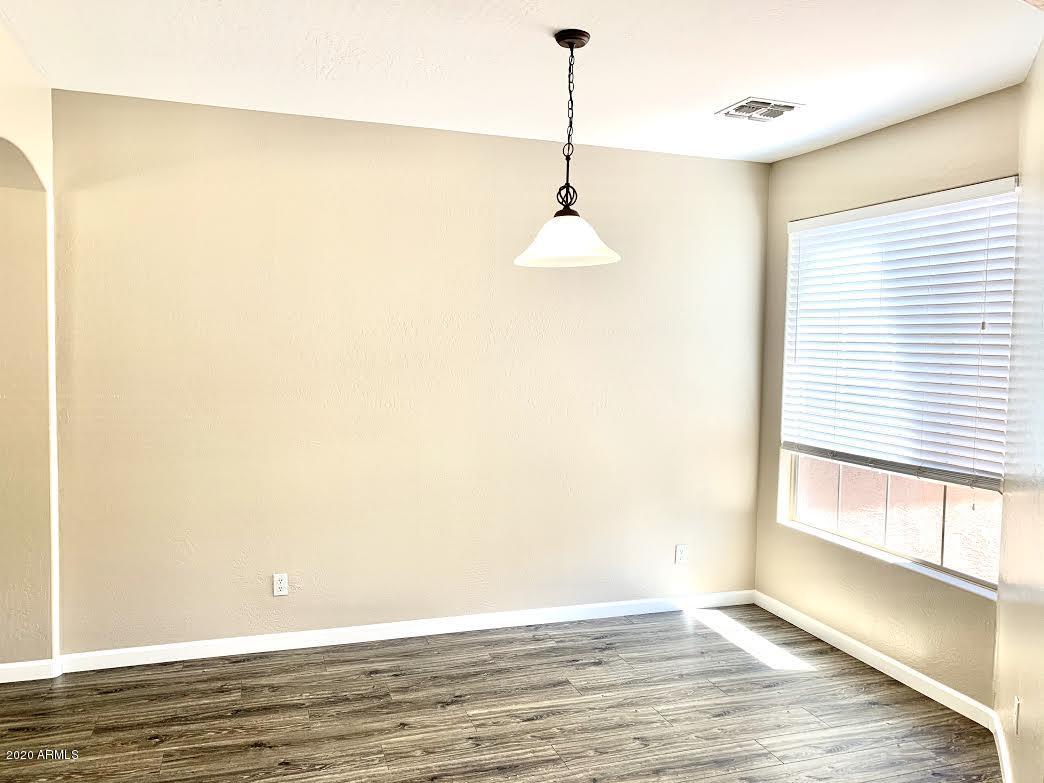 140 West Cardinal Way Chandler, AZ 85286 - Photo 16 of 44 a view of an empty room with wooden floor and a window